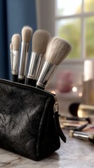 Makeup brushes in a black cosmetic bag