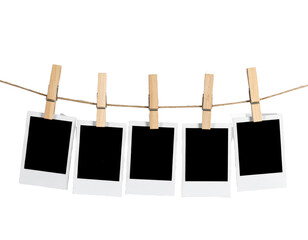 A row of five Polaroid frames pinned on a rope with clothespins showcasing simplicity and a 