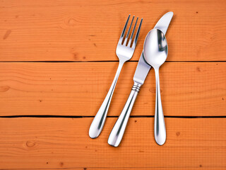 Fork, spoon, and knife arranged on orange wood surface. Ideal for dining or kitchen themes. Generative AI