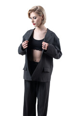 Portrait of a seductive, stylish business lady in the studio. Blonde girl in a suit and top.