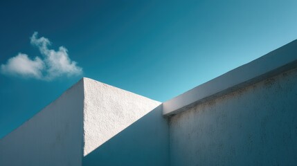 Close-up of a white concrete structure with dramatic sunlight and rich blue sky, minimalist urban aesthetic