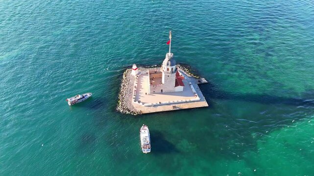 Aerial View of the Maiden's Tower in Istanbul, Turkiye with Boats. High-angle, full shot of the Kiz Kulesi (Leander's Tower) in ultrahd video, situated on a small, man-made island in the calm, 4k  