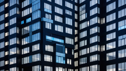Fototapeta premium window of a multi-storey building made of glass and steel, lighting and people on a blue background, shooting for business news and business