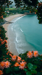 Serene coastal view framed by vibrant blossoms, showing a secluded beach and gentle waves