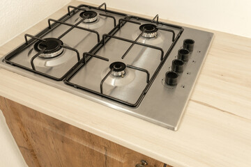 Modern integrated gas hob on kitchen surface. close up.