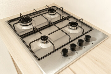 Modern integrated gas hob on kitchen surface. close up.