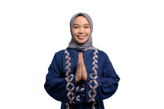 Smiling young Asian Muslim woman gesturing Eid Mubarak greeting isolated on transparent background
