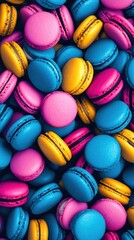 A colorful assortment of pink, blue, and yellow macarons piled together, creating a vibrant and appetizing display.
