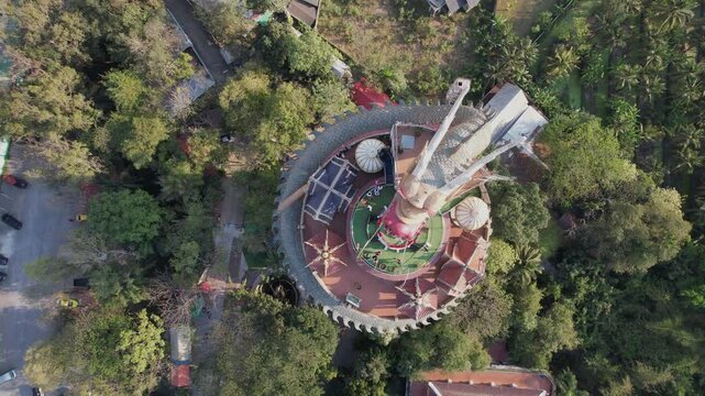 Aerial of visitors atop Wat Sam Phran Dragon Budist temple