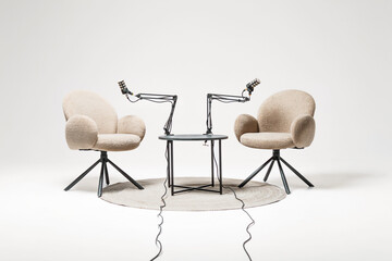 Two microphone-equipped chairs ready for podcast recording in a cozy lecture setting