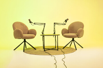 Podcast setup with two chairs and microphones designed for interviews and educational discussions...