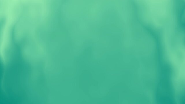 Blurry green background with a slight light shimmer. Ideal for nature themed designs, environmental concepts, or a calming backdrop for text overlay.