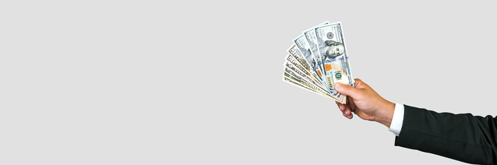 Banner, Close-up, American dollars money in the hand of a business man. White and gray background.