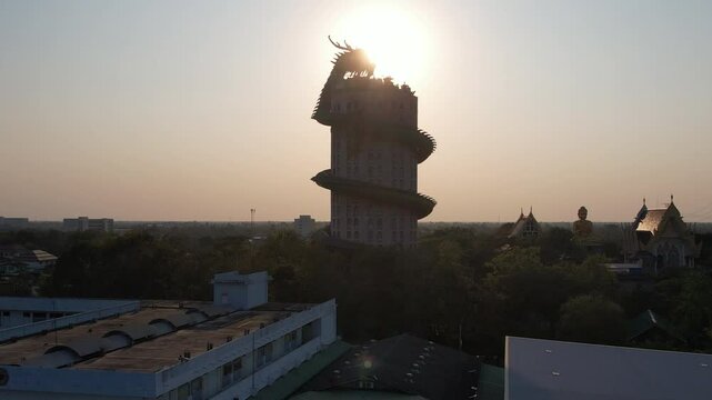 Aerial of Wat Sam Phran Dragon Budist temple at sunset