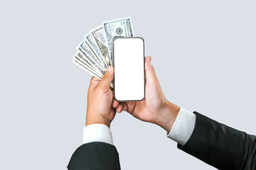 Close-up mockup of a smartphone with american money in the hands of a businessman. on a light gray background.