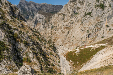 Stunning panoramic view of the dramatic rocky peaks and deep valleys of the Picos de Europa National Park in  Spain, showcasing rugged cliffs, narrow gorges. Popular destination for hiking, adventure.