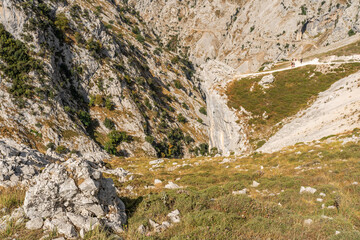 Stunning panoramic view of the dramatic rocky peaks and deep valleys of the Picos de Europa National Park in  Spain, showcasing rugged cliffs, narrow gorges. Popular destination for hiking, adventure.