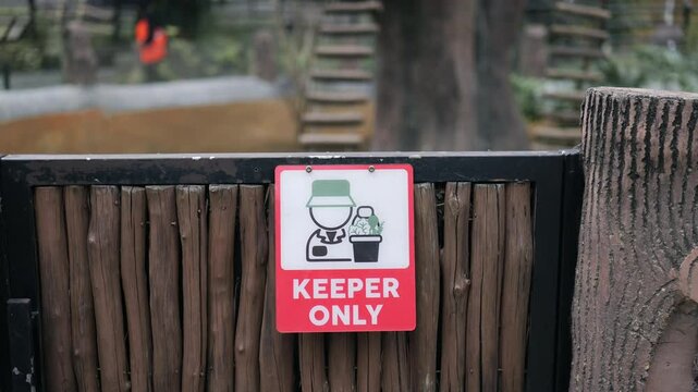 Footage of keeper only signage on animal cage at the zoo