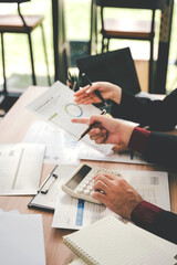 Young colleagues discussing business and price chart analyzes business people on the table great in modern coworking office teamwork concept. Calculate personal tax for customers