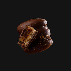Macaron cookie isolated on a dark grey background.