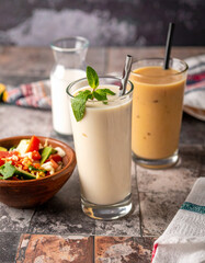 Traditional Salvadoran drinks, such as horchata or ensalada, presented in rustic glasses or bowls, showcasing local beverages.