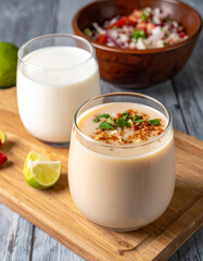 Traditional Salvadoran drinks, such as horchata or ensalada, presented in rustic glasses or bowls, showcasing local beverages.