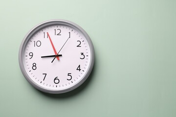 Close-up of a wall clock. The concept of time and work time is valuable for life, Alarm clock stopped. photo in a coloured background