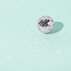 Shiny disco ball on bright background-. Space for text.	