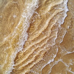 Aerial View of Gentle Waves on Sand with Reflection of Light