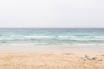 Waves rolling onto the sandy shore of Fuerteventura island