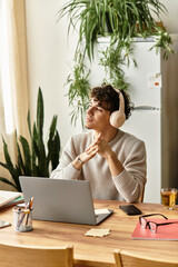 Handsome young man enjoying a creative moment while working at a stylish home office