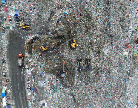 Aerial top view of excavators working on a landfill site in Medan, Indonesia – November 17, 2024