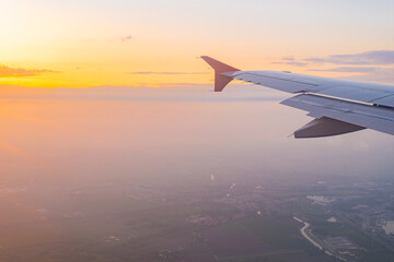 View from an airplane wing during sunset in serene skies