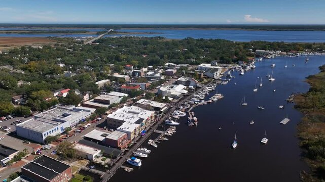 Small coastal town, historic Georgetown, SC showing Front Street shops with boardwalk beside Winyah Bay tourist destination and deep sea port