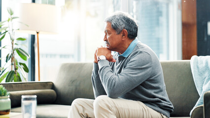Old man, thinking or reflection on couch in house for nostalgia, past or history with lonely...