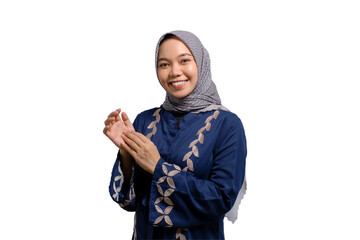 Smiling young Asian Muslim woman clapping hands, celebrating success with happy facial expressions...