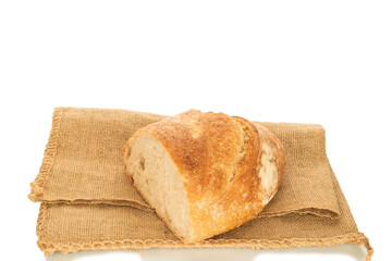 One half of a loaf of bread with a jute bag isolated on a white background, close-up.