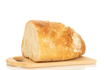 One half of a hearth bread on a bamboo board isolated on a white background, close-up.