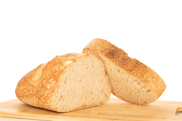 One half of a hearth bread on a bamboo board isolated on a white background, close-up.