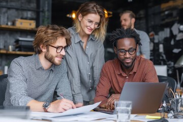 Diverse group collaborates on business project, utilizing laptop and analyzing documents in office setting, showing teamwork.