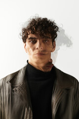 Fototapeta premium Striking young man in stylish attire showcasing modern confidence and charisma