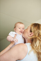 Mother holding in hands her cute infant at home