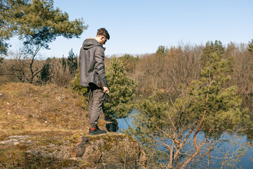 Fototapeta premium Young man fishing by the river