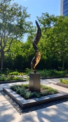 Bronze twisting sculpture in a landscaped courtyard