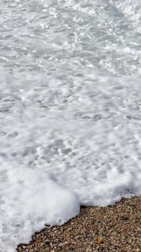 Huge waves crashing over Breakwater during winter storm Atlantic waves washing the lighthouse on Praia da Aguda sandy beach at Aguda settlement near Porto, Portugal. 4K vertical video.