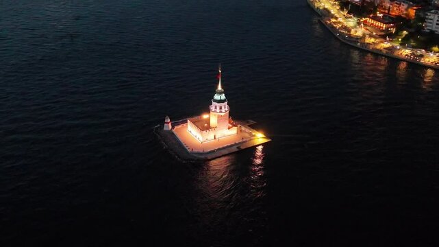 Aerial 4k ultrahd video of the Maiden's Tower illuminated at night.An aerial shot of the Kiz Kulesi (Leander's Tower) at night Istanbul Turkiye. Uskudar historical best touristic destination bosphorus
