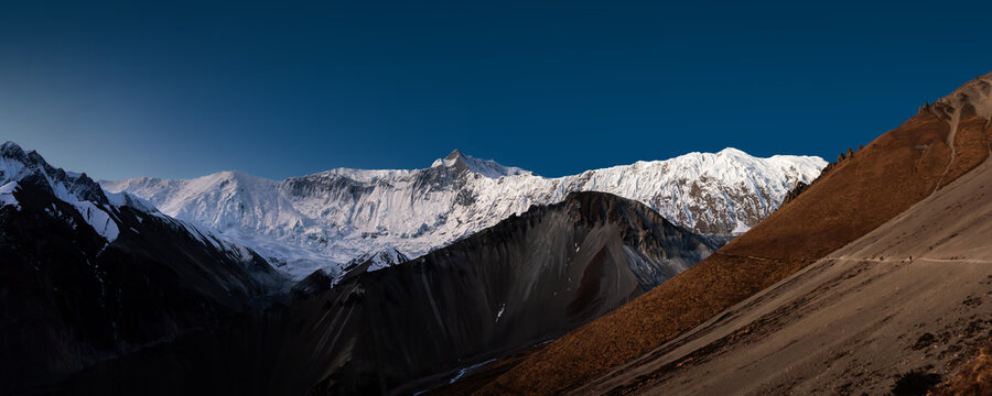 Huge snowy mountain range and trekking route to Tilicho lake before sunrise. Himalaya mountains, Nepal.