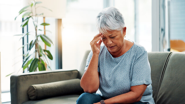 Senior woman, stress and sofa with headache for mistake, amnesia or dementia at home. Elderly, female person or mental health with migraine or loss for poor memory, alzheimers or illness at house