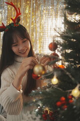 Two friends decorated Christmas tree at home.