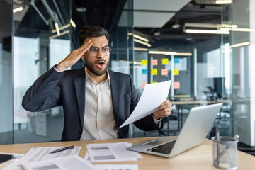 Upset and disappointed financier working on paperwork, man dissatisfied with performance results....